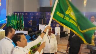 Gufran Ahmad mengangkat bendera Kadin setalah menang dalam pemilihan ketua umum Kadin Sulteng melakukan Musda provinsi